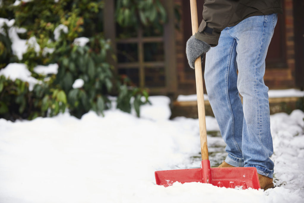 Man clearing snow from his driveway during extreme winter storm. 