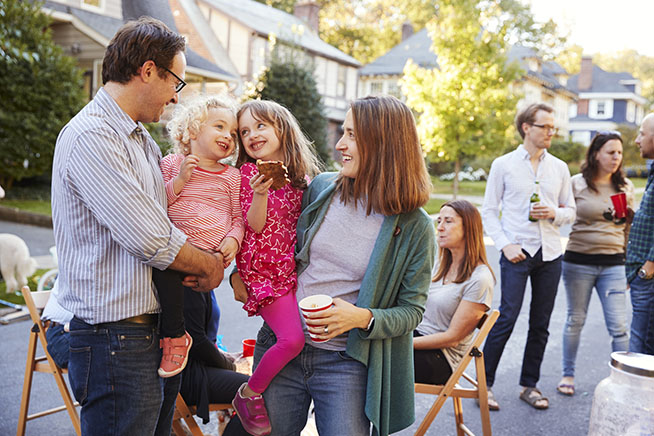 Tips for Meeting Your New Neighbors - Parents holding their young kids