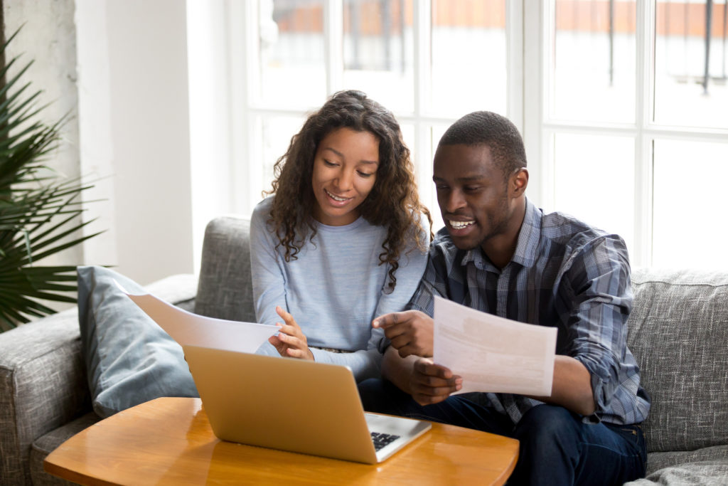 Young couple discussing finances and debt-to-income ratio