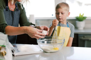 Mom and her son baking in their new home - Tips and Ideas to Keep Kids Busy Over the Holiday Break